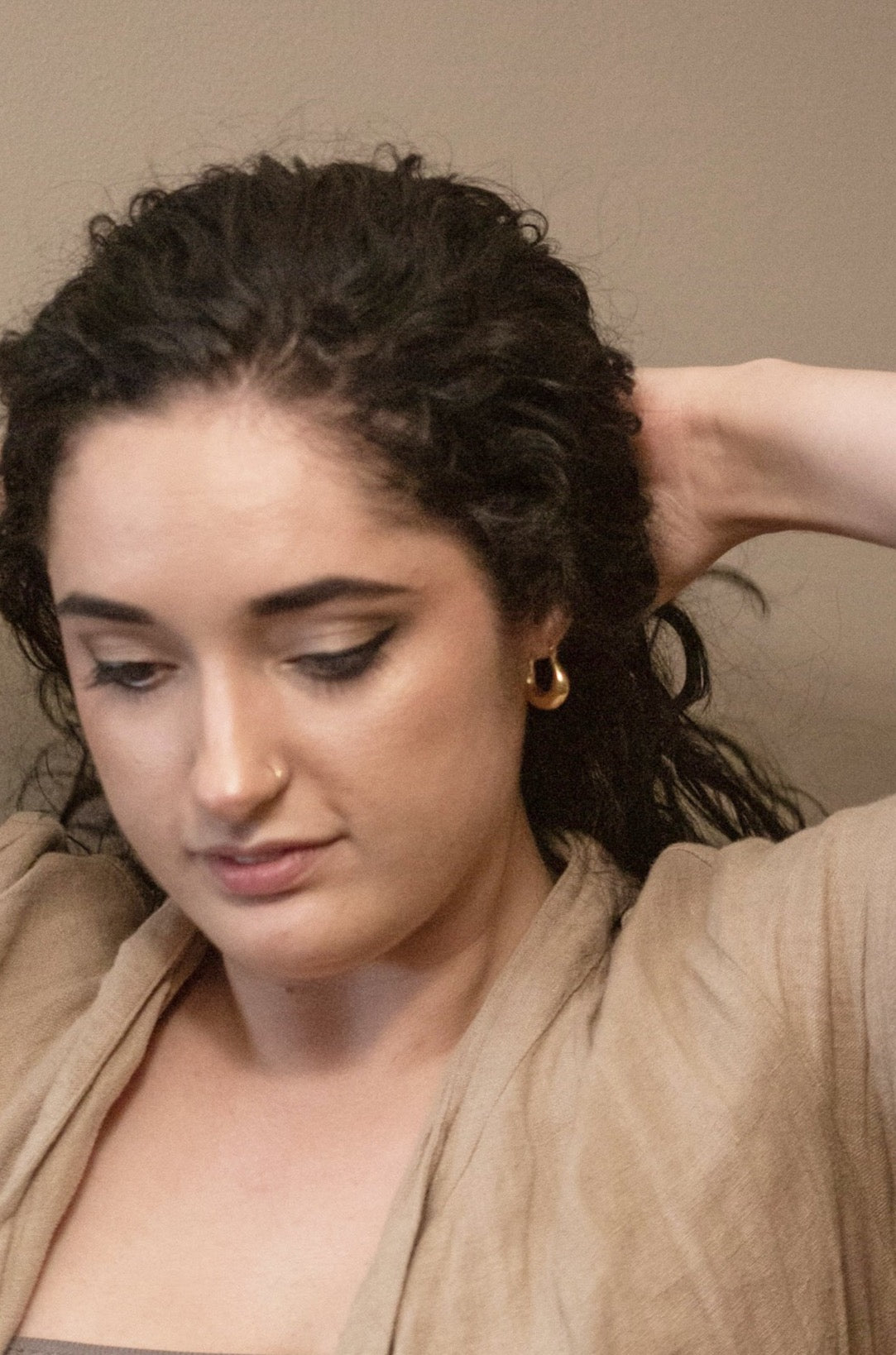 A photograph of the earring on the model, showcasing the size and shape of the earring.