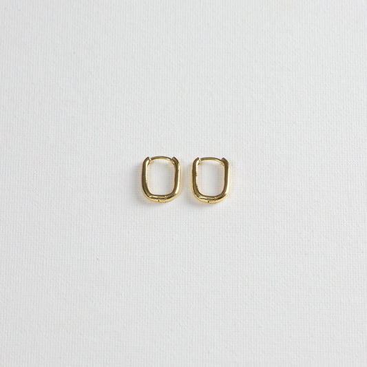 Asa hoops, gold hoops with rounded rectangle shape, on a white background.