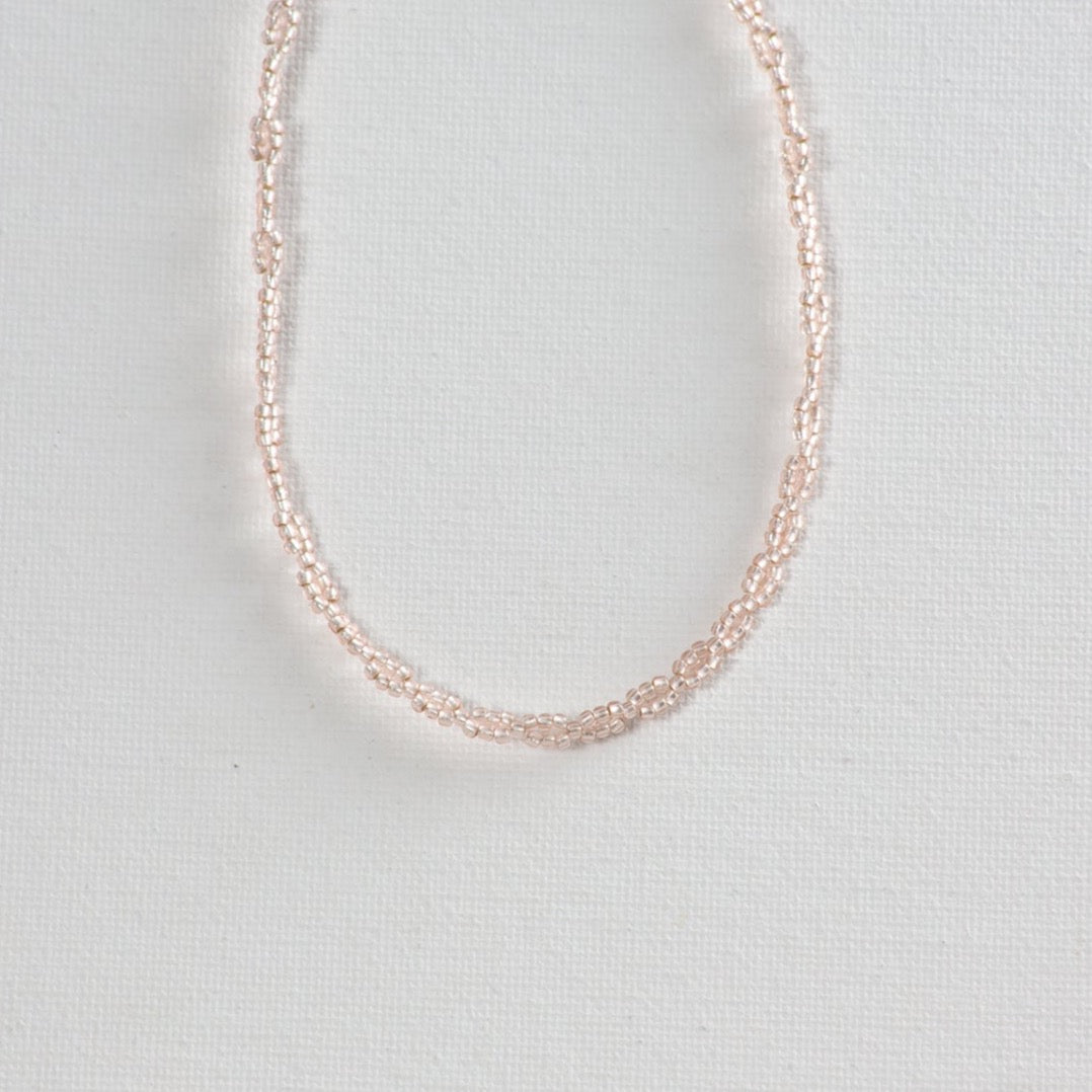 Infinity pattern beaded choker showcased on a clean white background.
