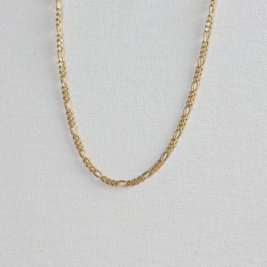 Figaro chain necklace displayed on a white background. The necklace showcases a classic design with alternating flattened links.
