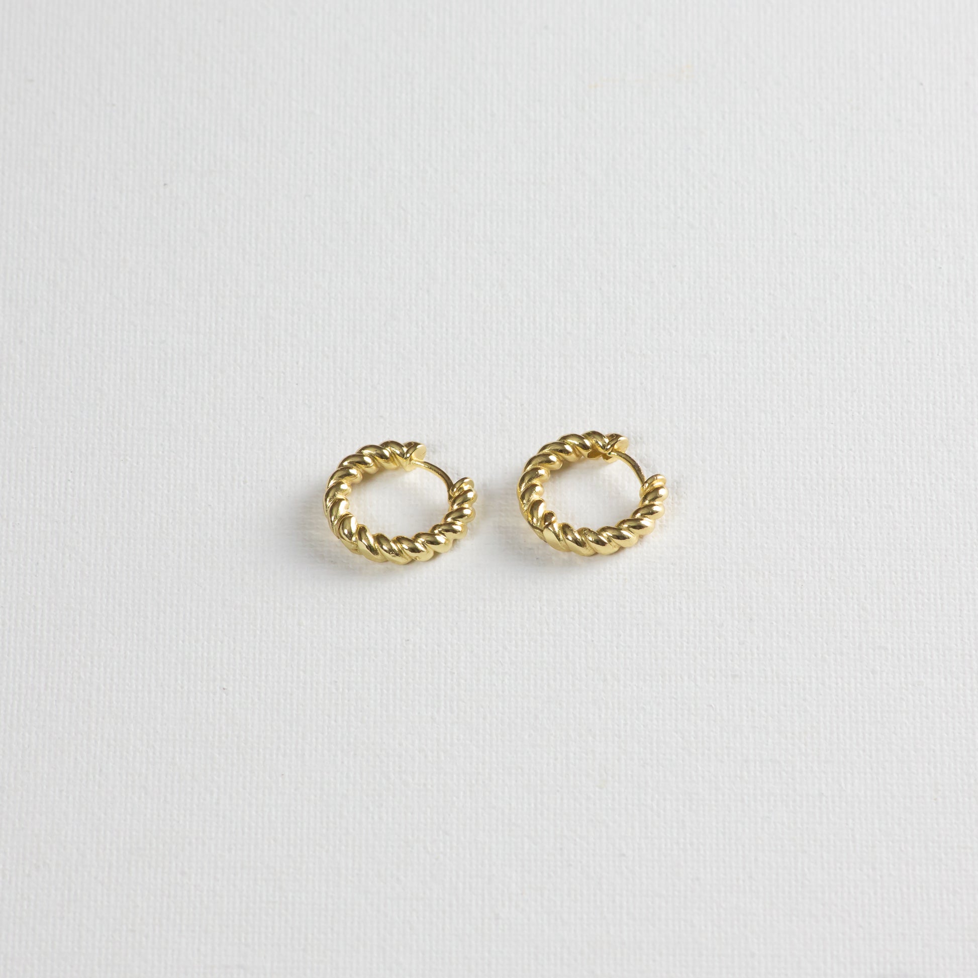 A different angle of the Honey crueller hoops on a white background.