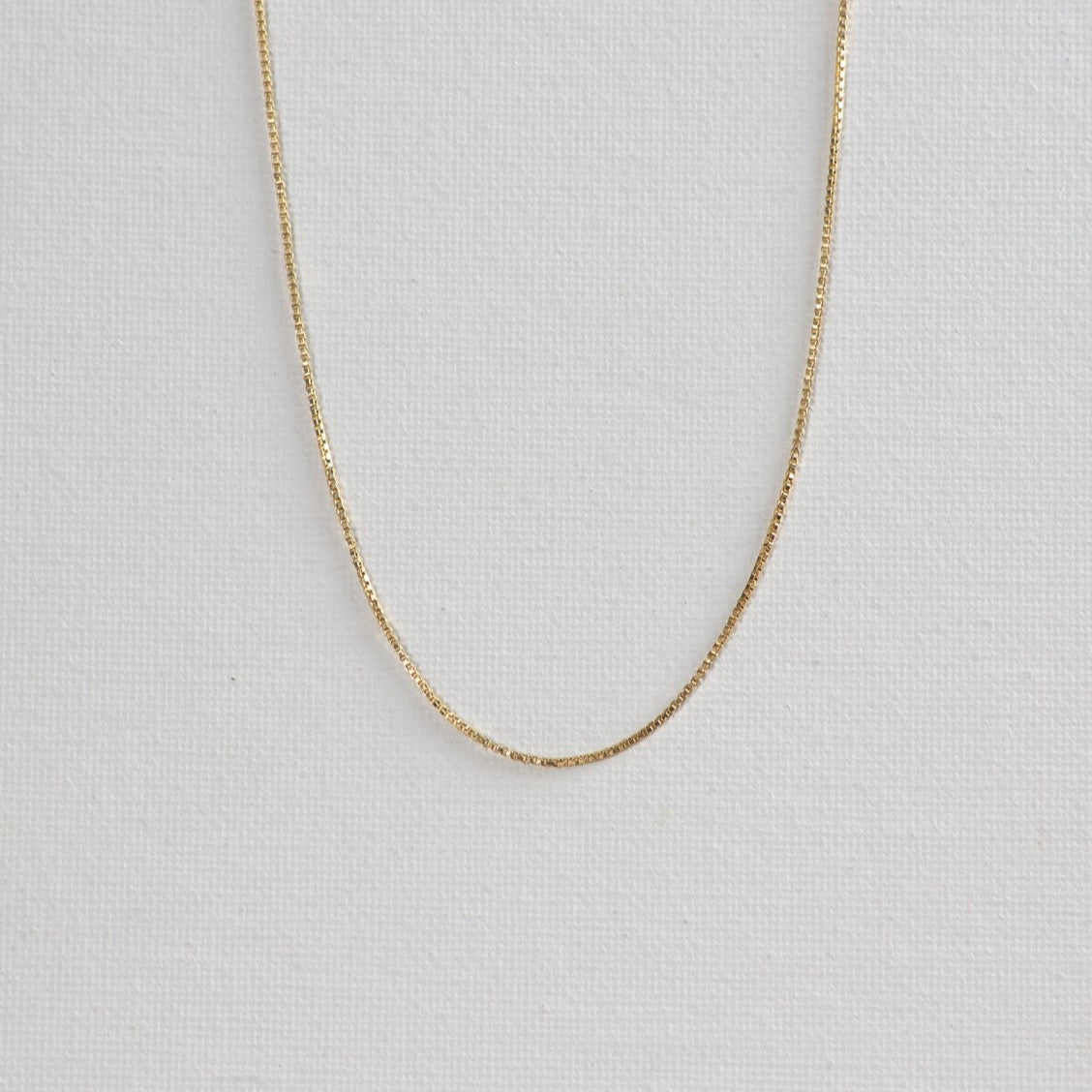 Baby box chain necklace photographed on a white background.