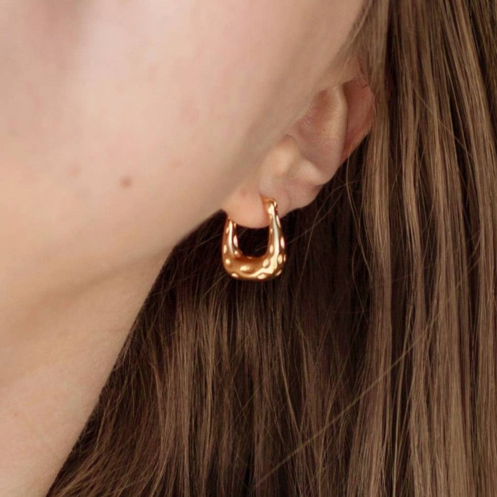 A photo that showcases how the earring looks on a model.