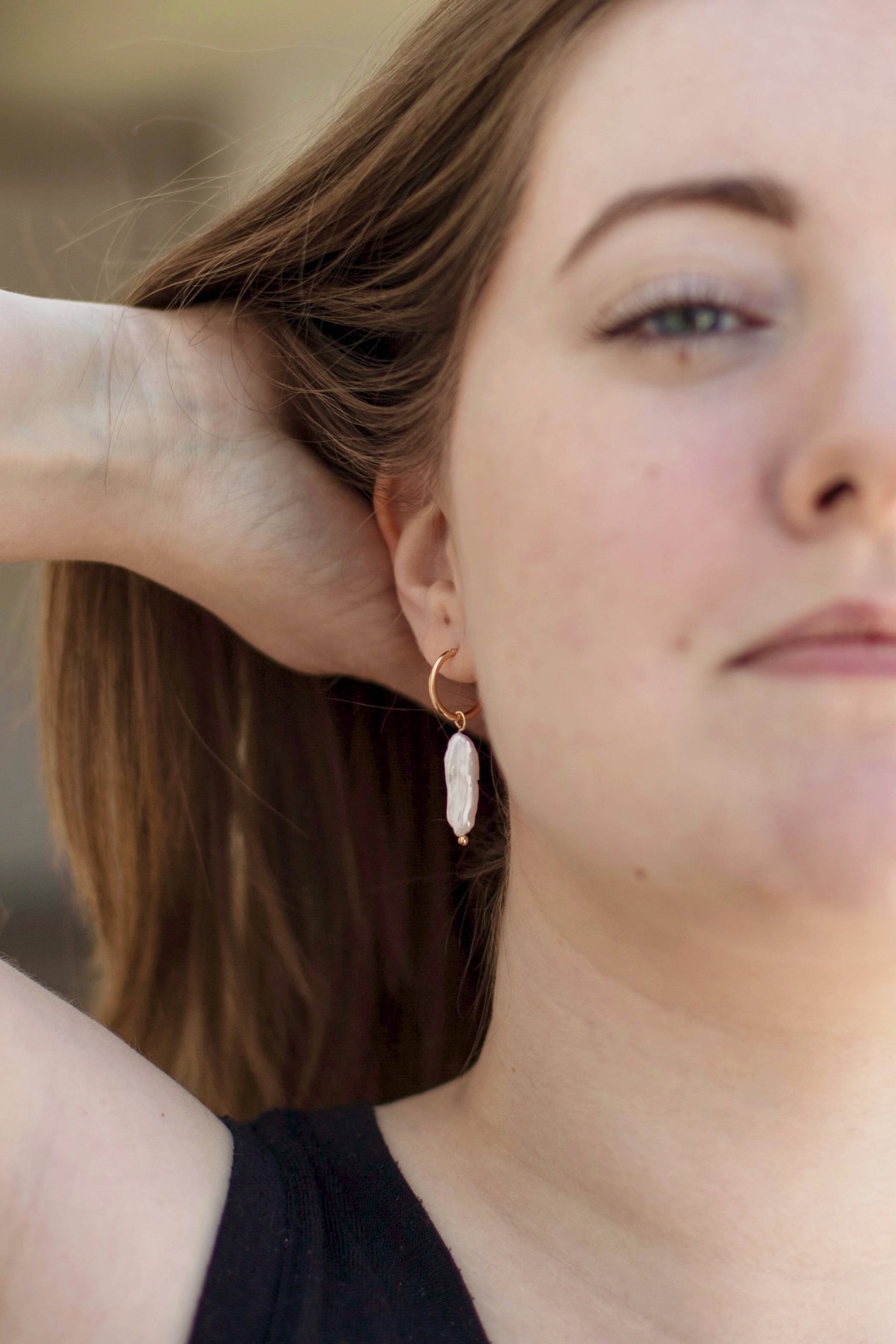 A model wearing the earrings, to showcase the true size and how the pearl accentuates her neck.
